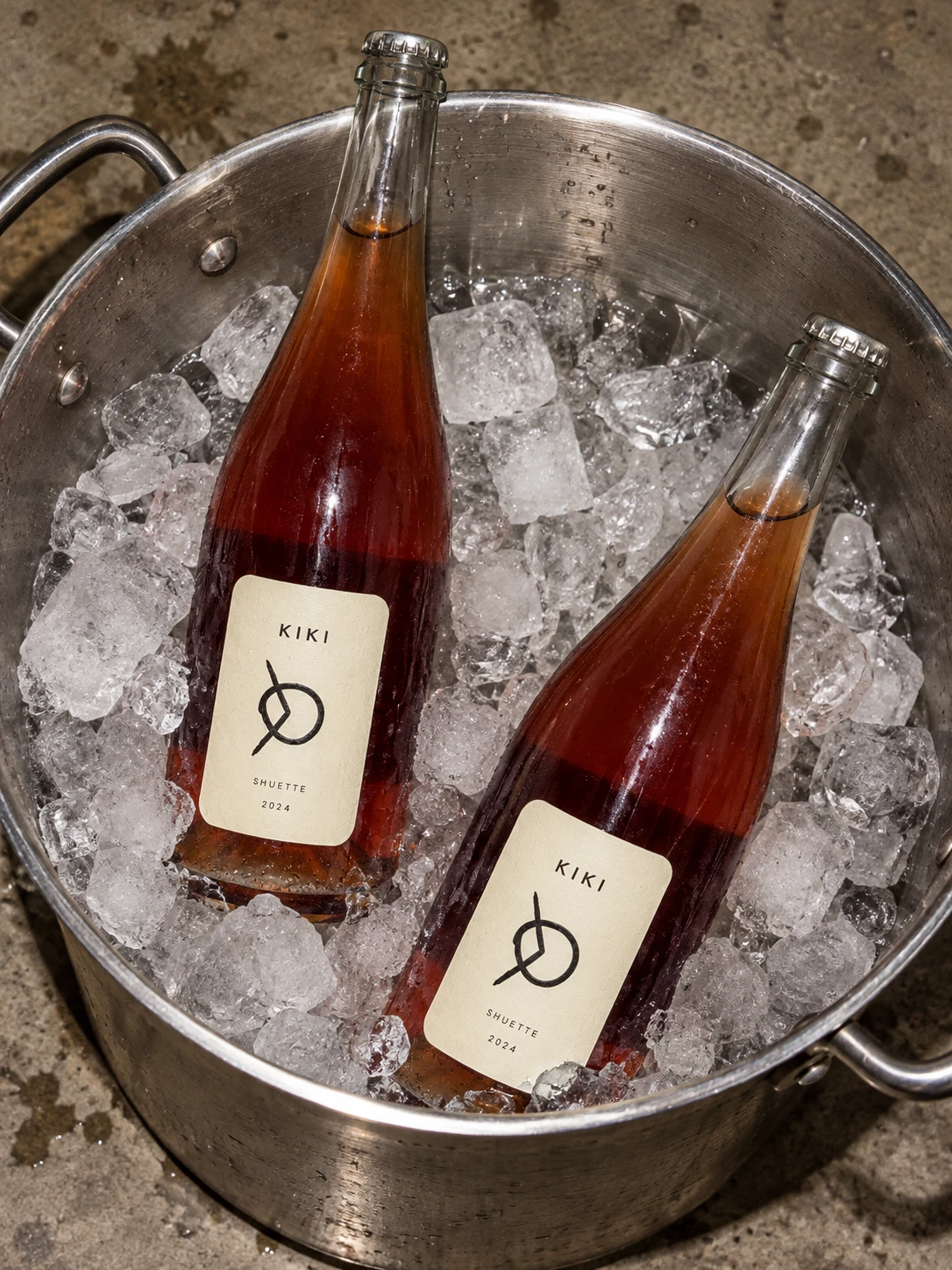 Two bottles of Kiki rosé pét-nat chilling in a stockpot of ice