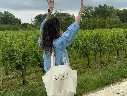 White Château Shuette tote bag carried beside the vineyard