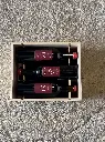 Open wooden wine box holding three Sanguis bottles